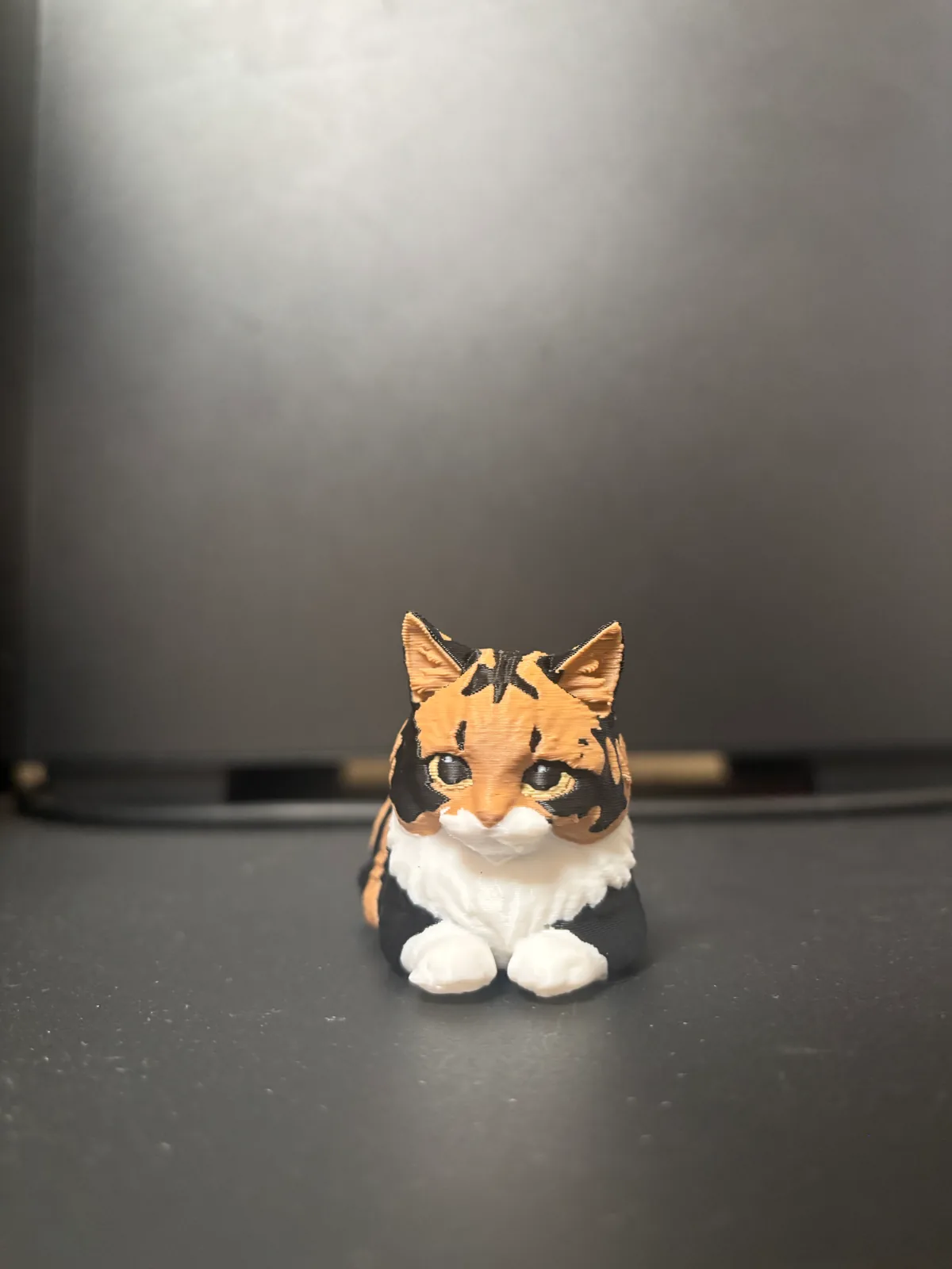 Finished physical figurine of Poonie lying down
